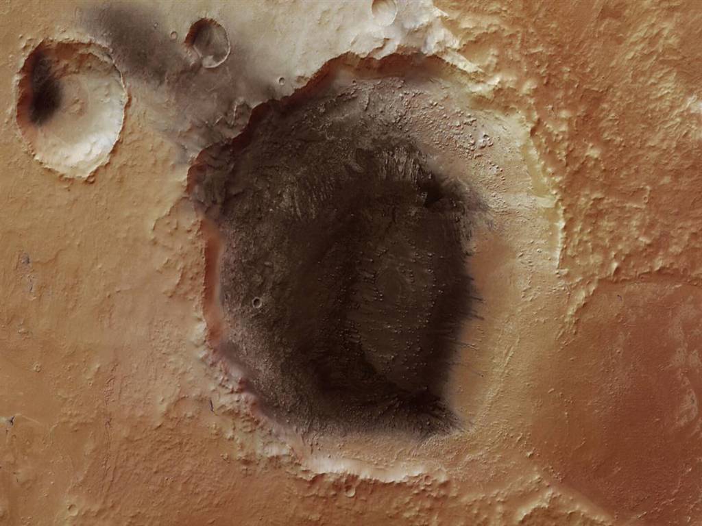 Đây là hình ảnh các lớp lắng cặn do bụi núi lửa sinh ra tại khu             vực Meridiani Planum trên bề mặt sao Hoả. Bức ảnh do trạm quỹ đạo Mars             Express của Cơ quan Vũ trụ châu Âu chụp và công bố ngày 12/5.