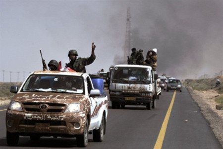 Một đoàn xe chở các tay súng đối lập tiến theo hướng tây về phía thành phố Sirte ở miền trung hôm 28/3. Ảnh: AFP.