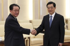 China's President Hu shakes hands with Jang, Chief of Central Administrative Department of Workers' Party of Korea, in Beijing