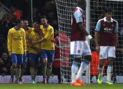 Arsenal's Walcott celebrates with team mates after scoring a goal against West Ham United during their English Premier League soccer match at the Boleyn Ground in London