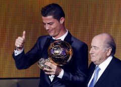 Portugal's Cristiano Ronaldo gestures beside FIFA President Sepp Blatter after being awarded the FIFA Ballon d'Or 2013 in Zurich J