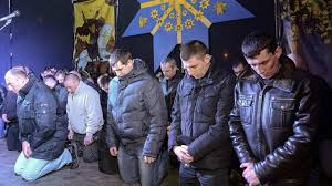 Cảnh sát chống bạo động của thành phố Lvov bị bắt quỳ xin lỗi cư dân thành phố hôm 24-2, vì tham gia chiến dịch trấn áp người biểu tình trước đây - Ảnh: Reuters