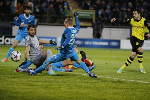Borussia Dortmund's Mkhitaryan scores past Zenit St Petersburg's Anyukov and goalkeeper Lodygin during their Champions League soccer match in St. Petersburg