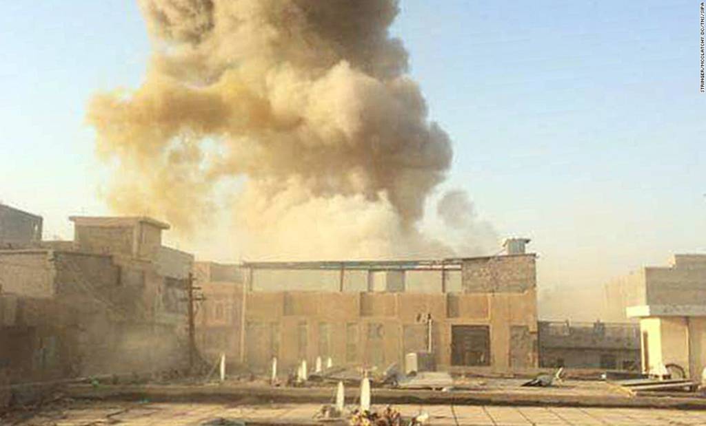A car bomb, believed to be set by ISIS militants, explodes at the gate of a government building near the provincial governor's compound in Ramadi, Iraq, on Saturday, May 16.