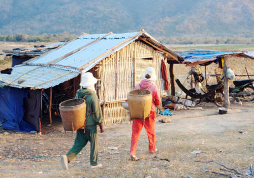 Người dân thôn Ma Nai, xã Phước Thành xuống lòng hồ cất chòi tạm ở lại sản xuất nông nghiệp. Ảnh: Tư Huynh