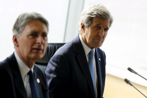 U.S. Secretary of State John Kerry (R) and his fellow G7 foreign ministers including Britain's Foreign Minister Philip Hammond (L) take their seats for a working session, the fourth session of the their meetings in Hiroshima, Japan April 11, 2016. REUTERS/Jonathan Ernst