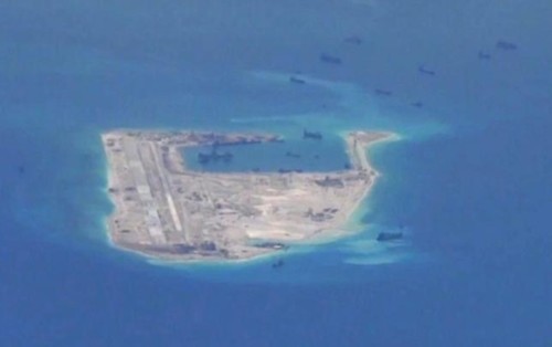 Chinese dredging vessels are purportedly seen in the waters around Fiery Cross Reef in the disputed Spratly Islands in the South China Sea in this still image from video taken by a P-8A Poseidon surveillance aircraft provided by the United States Navy May 21, 2015.
