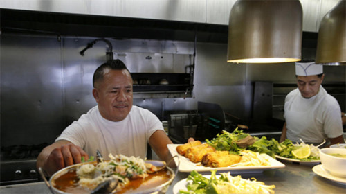 Los Angeles TimesChef Juan Ramirez, left, and Omar Reynoso, right, prepare meals at hotspot Song Long. Despite their political differences the Vietnamese tend to be Republican, and the Latinos Democratic experts say they come together to solve a labor shortage facing the area.