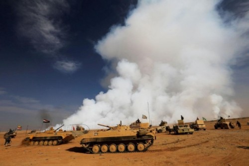 Iraqi troops gather after the liberation of a village from Islamic State militants, south of Mosul, during an operation to attack Islamic State militants in Mosul. (THAIER AL-SUDANI/REUTERS)