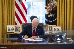 U.S. President Joe Biden signs executive actions in the Oval Office of the White House in Washington, D.C., U.S., on Thursday, Jan. 28, 2021. Biden will make it easier for Americans to buy health insurance during the pandemic, reopening the federal Obamacare marketplace with an order that's a step toward reinvigorating a program his predecessor tried to eliminate. Photographer: Doug Mills/The New York Times/Bloomberg via Getty Images